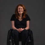 Chloe Kennedy in a wheelchair smiling
