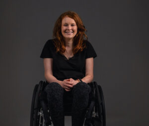 Chloe Kennedy in a wheelchair smiling