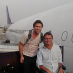 Philip and a carer next to a plane