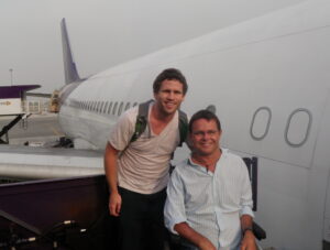 Philip and a carer next to a plane