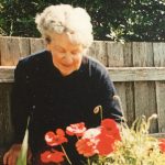 Image of Gwenyth in the garden with red tulips