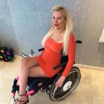 Lolly Mack in wheelchair and red dress