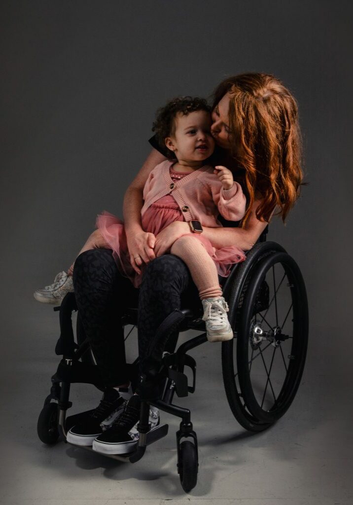 Chloe in wheelchair with her two year old daughter